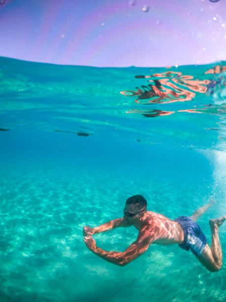 One man, a young man diving into the sea. Photographed with a GoPro camera in a DOME case.